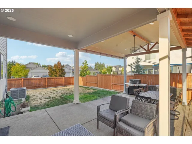 a view of a porch with furniture and a yard