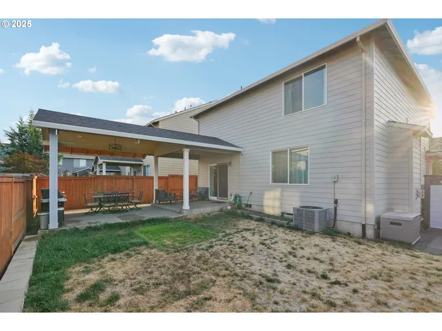 a view of a house with a yard and sitting area