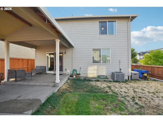 a view of house with backyard and outdoor seating