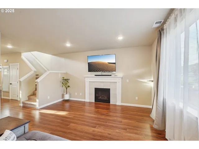 a view of a livingroom with an empty space and a fireplace