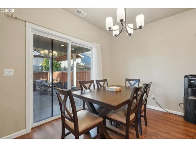 a view of a dining room with furniture wooden floor and chandelier