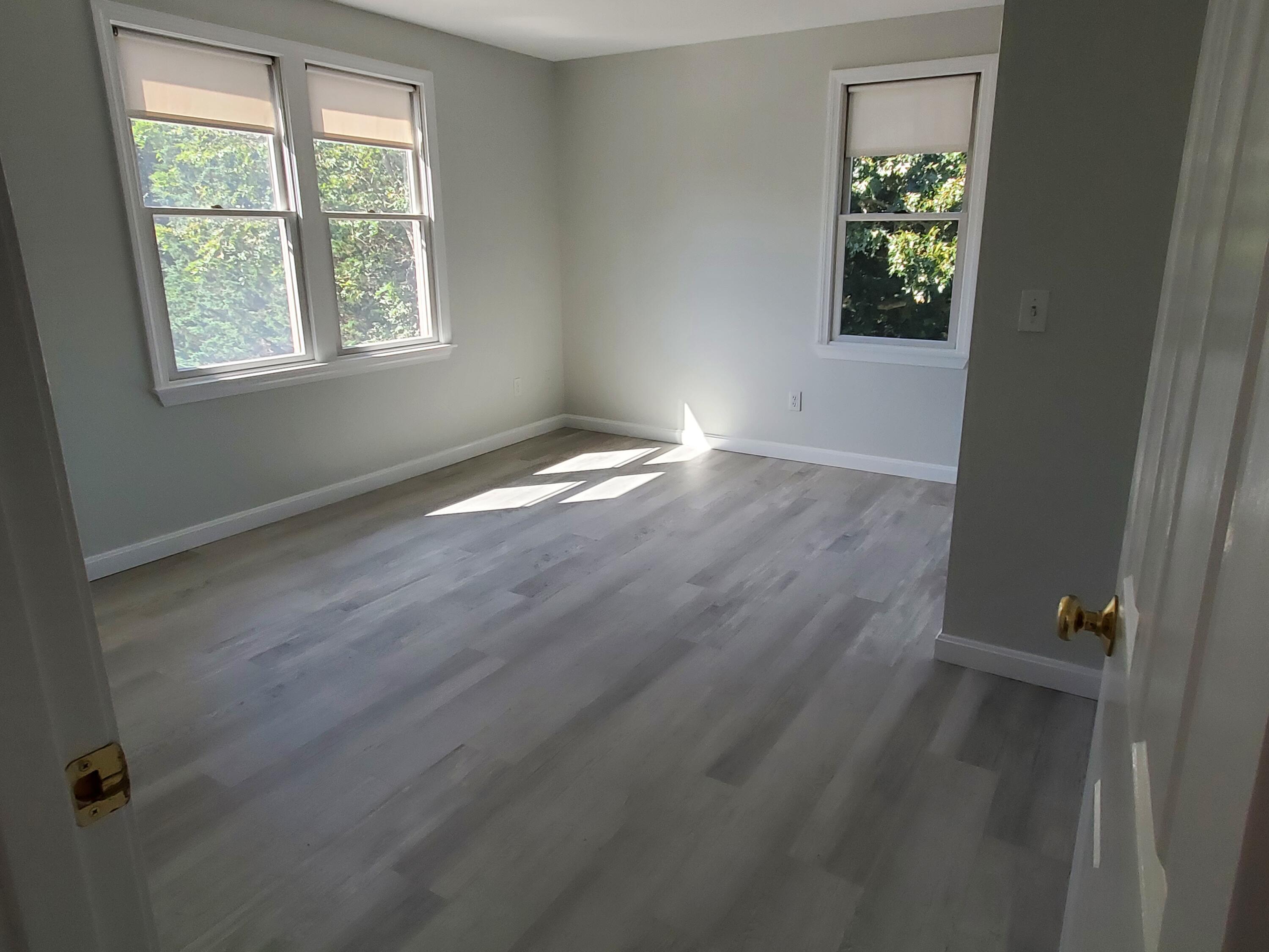 35 Brittany's Way Eastham, MA 02642 - Photo 11 of 30 an empty room with wooden floor and windows