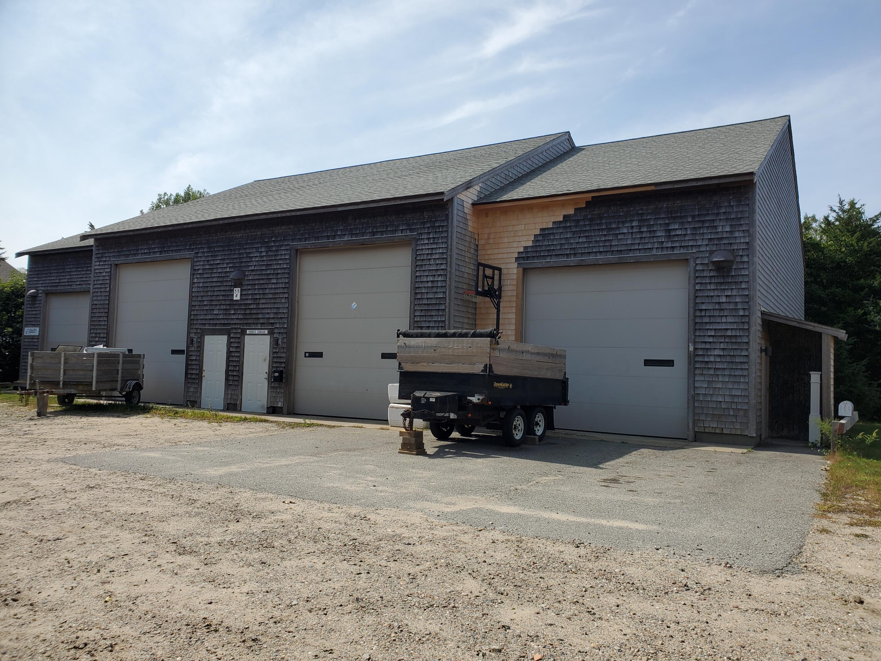 35 Brittany's Way Eastham, MA 02642 - Photo 26 of 30 a front view of a house with garage