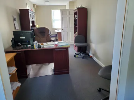 a living room with furniture and a mirror