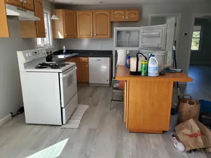 a kitchen with stainless steel appliances granite countertop a refrigerator stove a sink and dishwasher