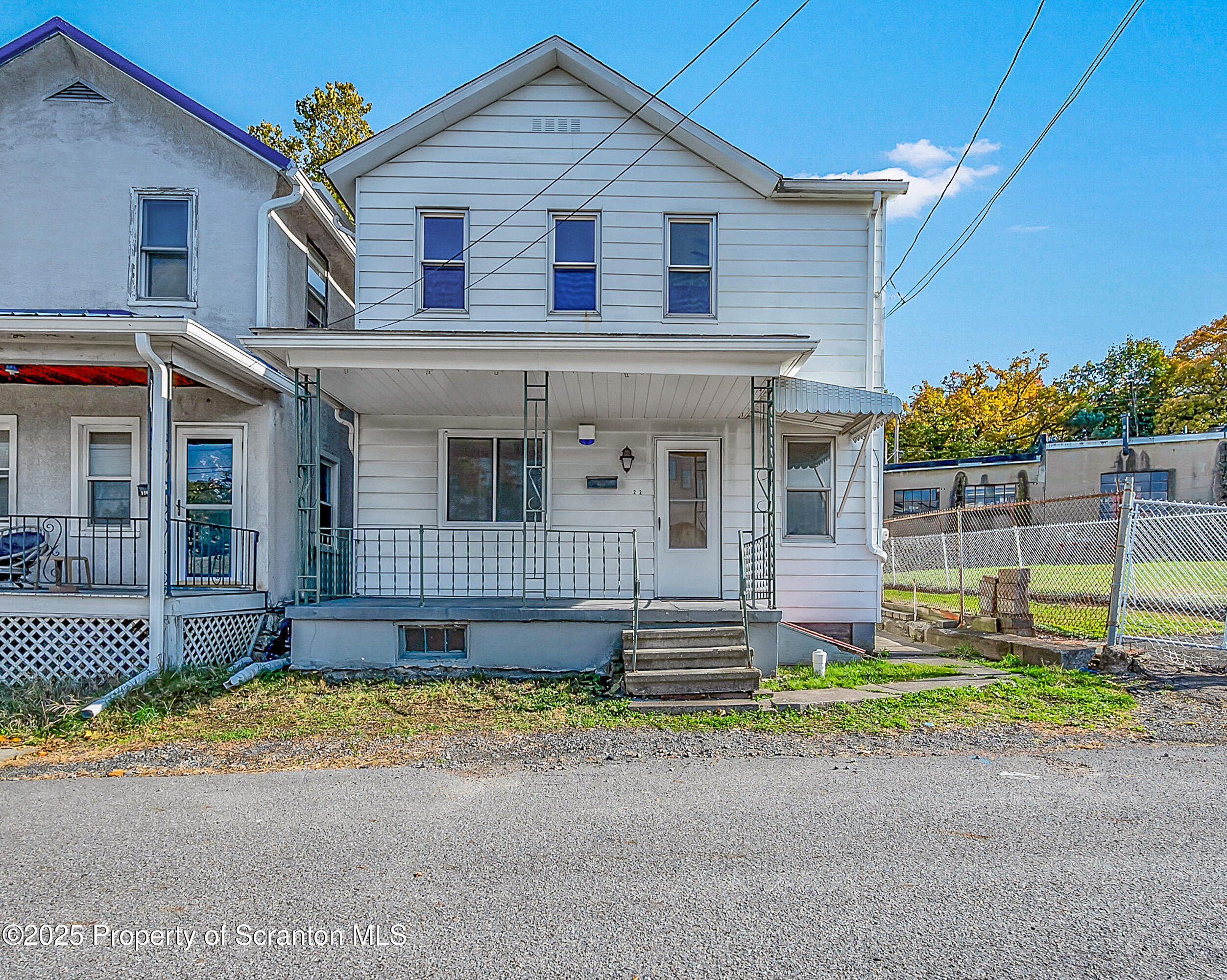 1202 North Webster Avenue, Unit REAR Dunmore, PA 18510 - Photo 13 of 21 a front view of a house with a yard and potted plants