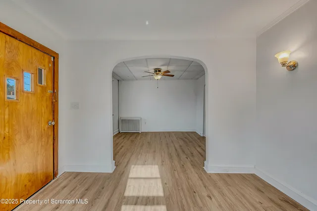 a view of a bedroom with wooden floor and closet