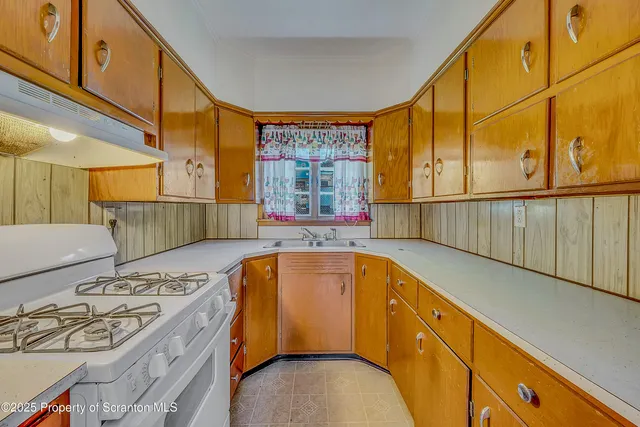 a view of a kitchen with a sink and furniture