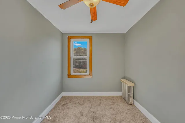 a view of an empty room with windows