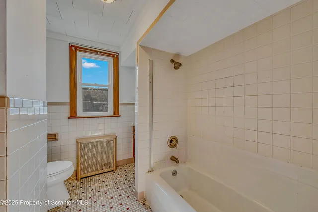 a bathroom with a bathtub and shower