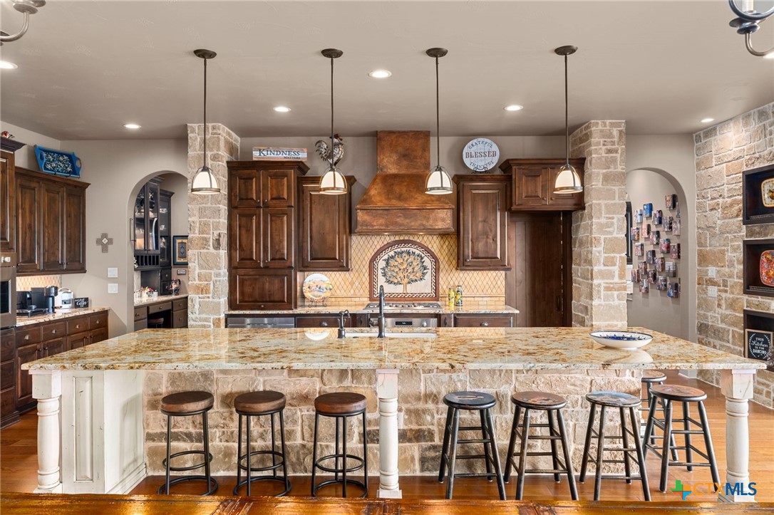 1039 Bluewater Place Spring Branch, TX 78070 - Photo 22 of 48 a kitchen with lots of counter space and chandelier