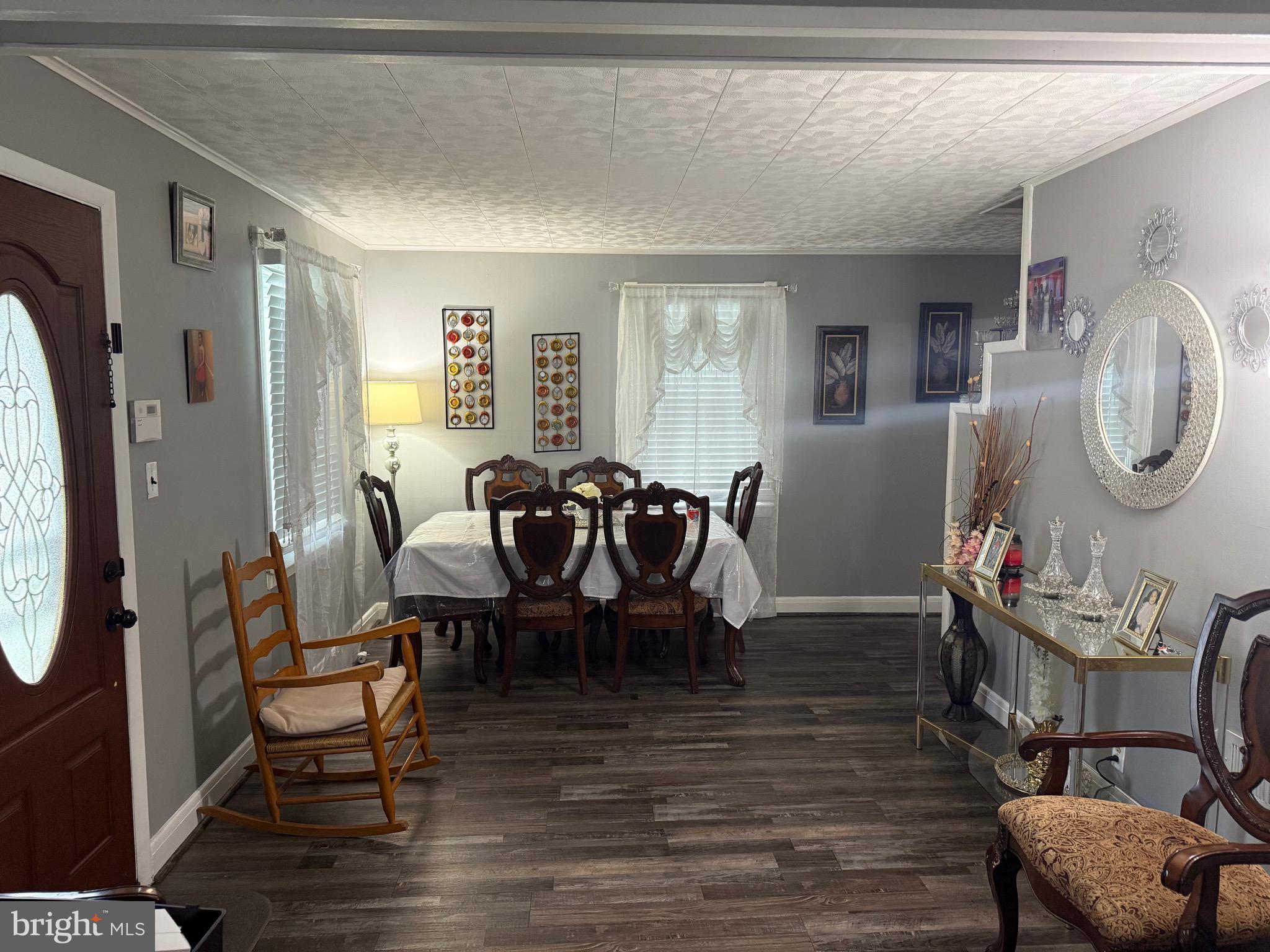 1346 Willow Road Baltimore, MD 21222 - Photo 29 of 81 a dining room with furniture a potted plant and wooden floor