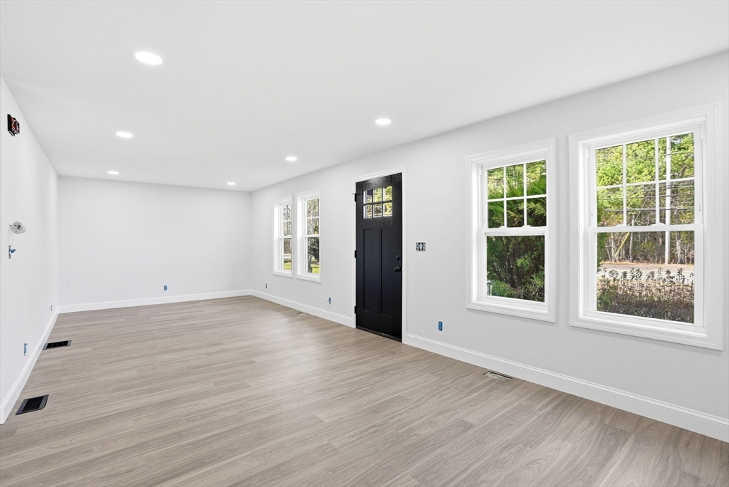 357 Wareham Street Middleboro, MA 02346 - Photo 10 of 42 an empty room with wooden floor and windows