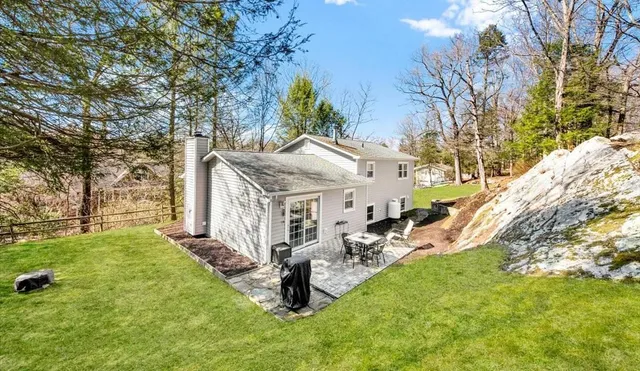a view of a house with a yard porch and sitting area
