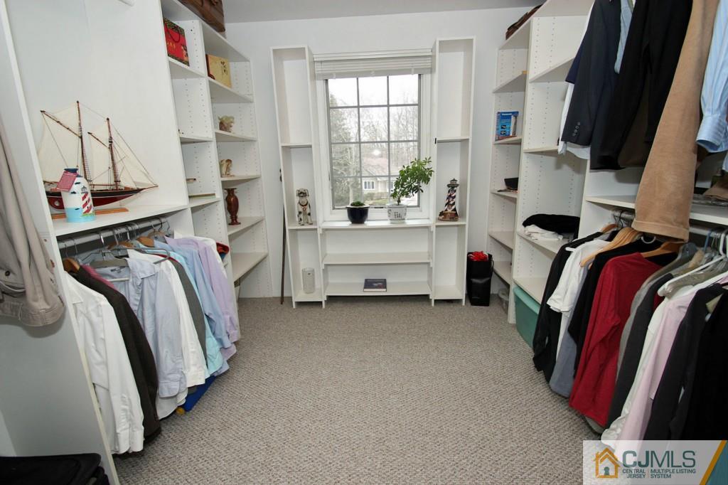 32 Timber Road Edison, NJ 08820 - Photo 11 of 25 a view of walk in closet with clothes and shoes