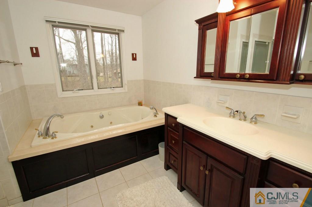 32 Timber Road Edison, NJ 08820 - Photo 12 of 25 a bathroom with a double vanity sink and mirror