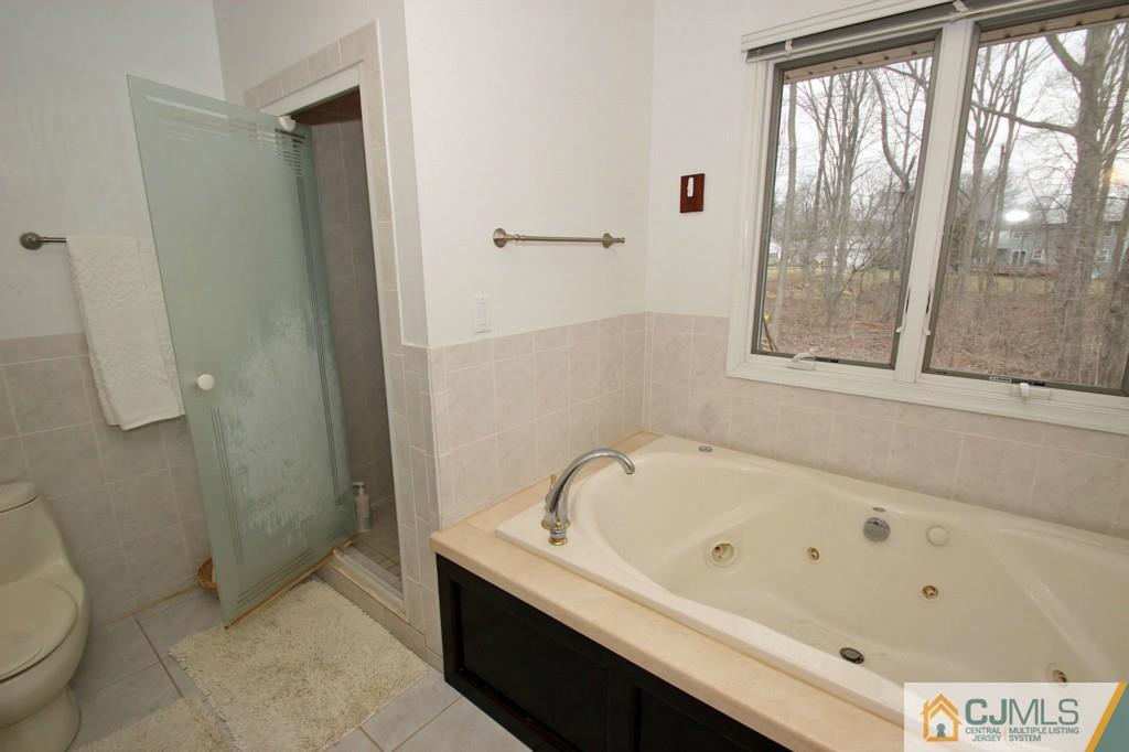 32 Timber Road Edison, NJ 08820 - Photo 13 of 25 a bathroom with a bathtub and a shower
