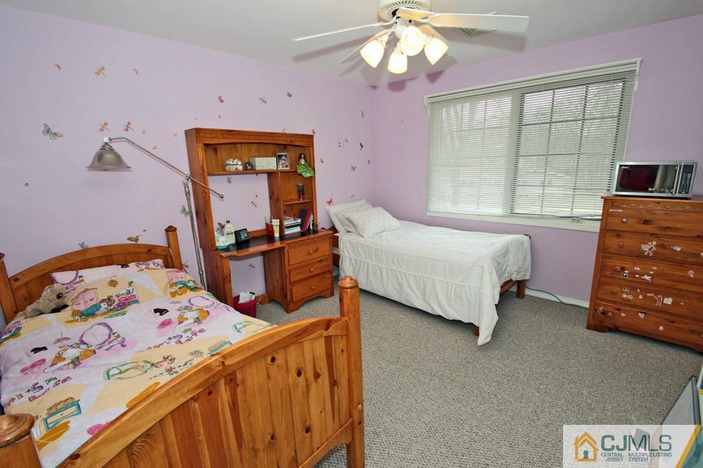 32 Timber Road Edison, NJ 08820 - Photo 15 of 25 a bedroom with a bed and a tv