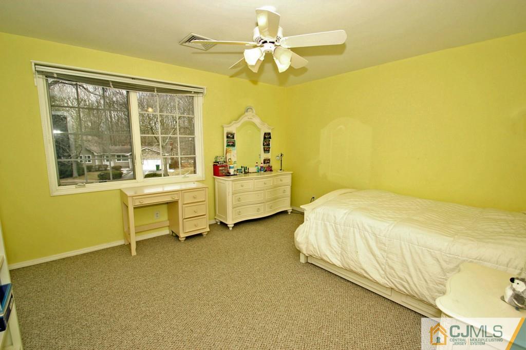 32 Timber Road Edison, NJ 08820 - Photo 16 of 25 a bedroom with a bed and a table