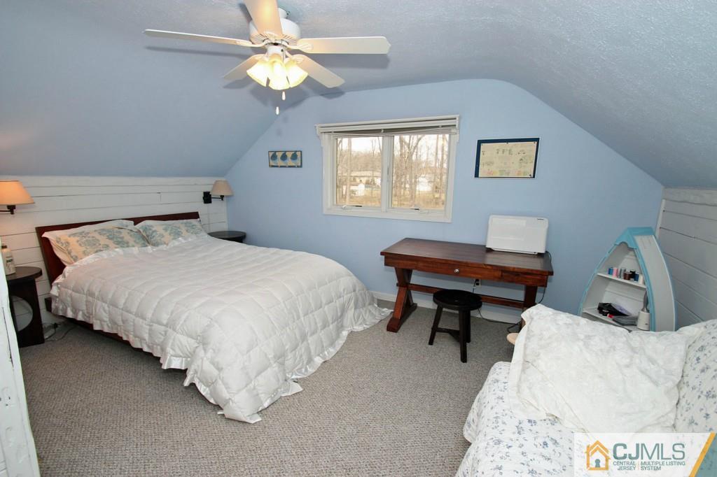 32 Timber Road Edison, NJ 08820 - Photo 18 of 25 a bedroom with a bed and a chandelier