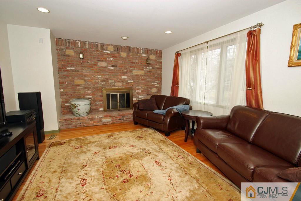 32 Timber Road Edison, NJ 08820 - Photo 4 of 25 a living room with furniture fireplace and flat screen tv