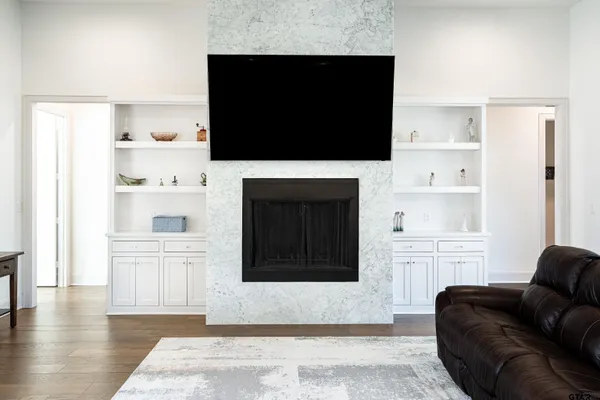 a living room with a flat screen tv and a fireplace