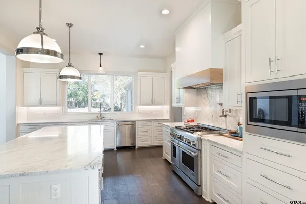 a bathroom with a granite countertop double vanity sink and a mirror