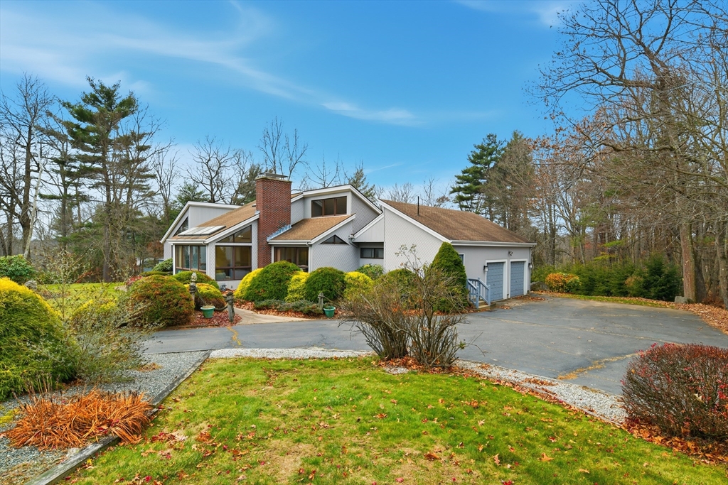 a front view of a house with a garden