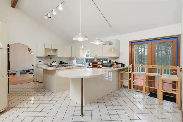 a kitchen with cabinets and chairs