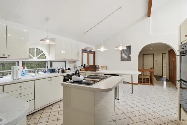 a kitchen with sink a stove and cabinets