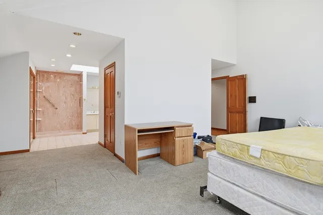 a bedroom with a bed and a dresser