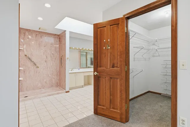 an empty room with mirror and shower