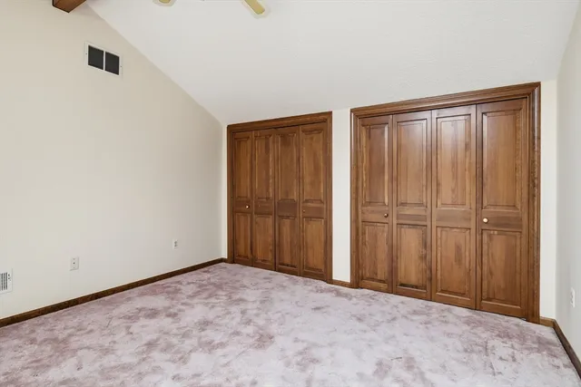 a view of a hallway with wooden floor and fence