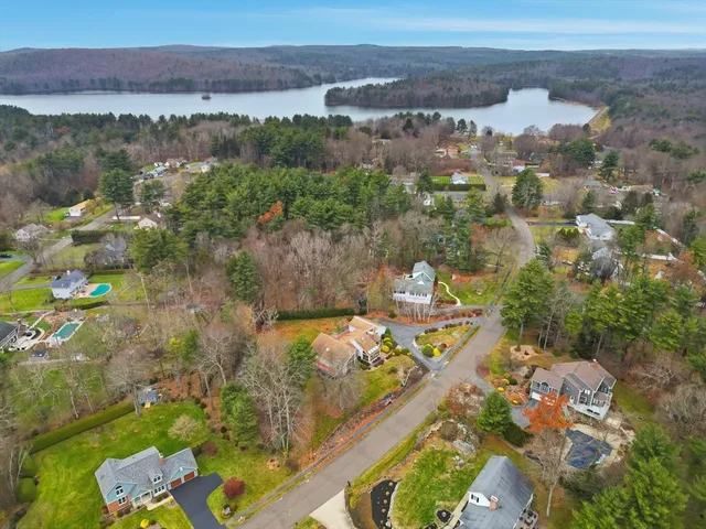 an aerial view of a house with swimming pool and porch