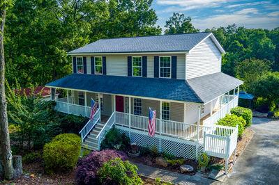 a aerial view of a house with a yard and potted plants