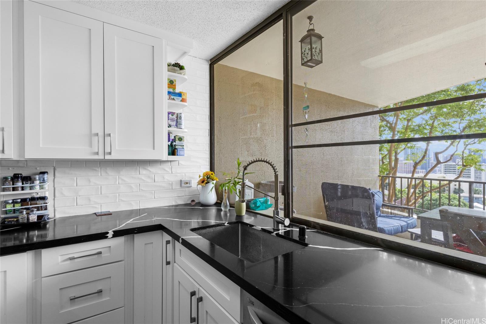 965 Prospect Street, Unit 404 Honolulu, HI 96822 - Photo 12 of 24 a kitchen with granite countertop a sink a stove and cabinets