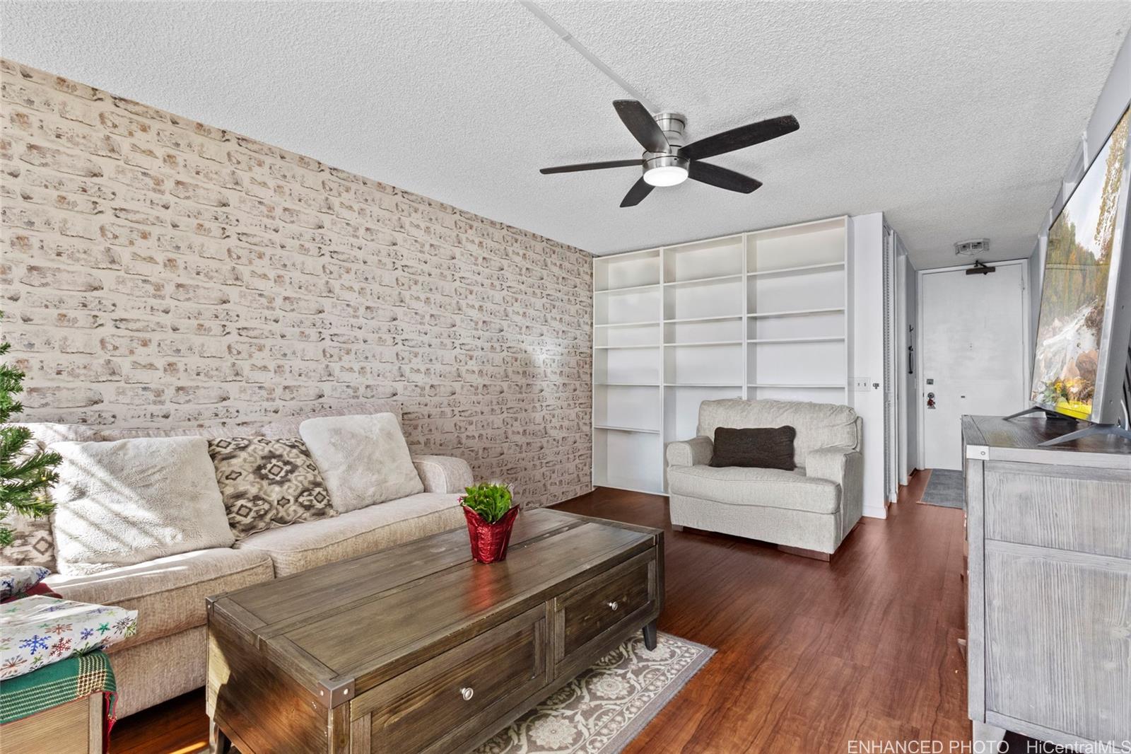 965 Prospect Street, Unit 404 Honolulu, HI 96822 - Photo 2 of 24 a living room with furniture and a fireplace