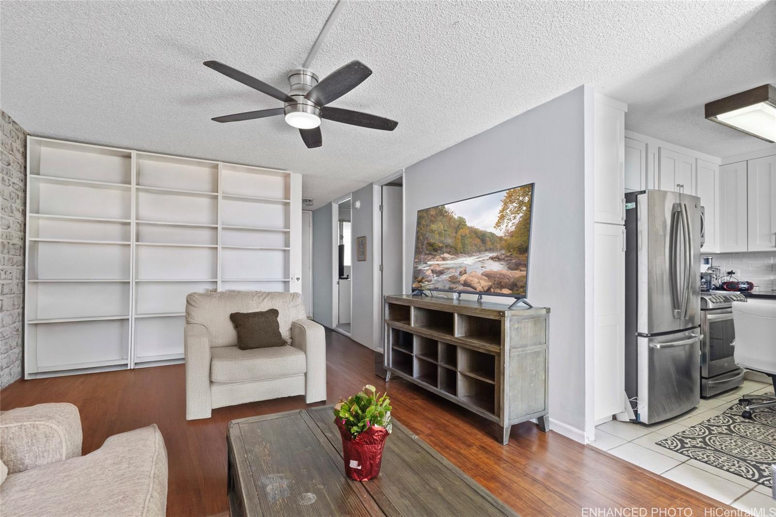 965 Prospect Street, Unit 404 Honolulu, HI 96822 - Photo 3 of 24 a living room with furniture and a flat screen tv