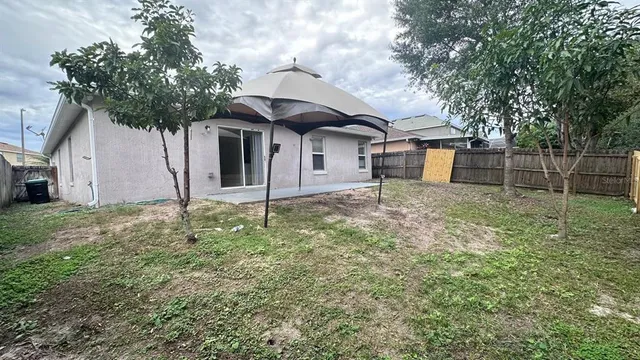 a front view of a house with plants