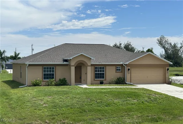 a front view of a house with a garden