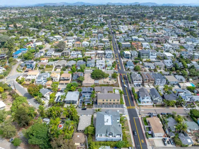 an aerial view of residential houses with city view