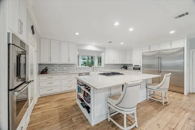 a view of kitchen and living room with wooden floor