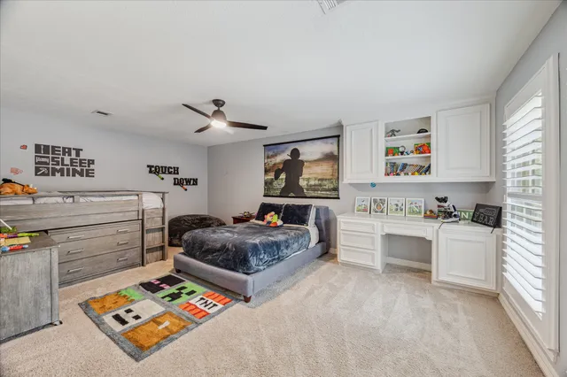 a bathroom with a granite countertop toilet sink and mirror