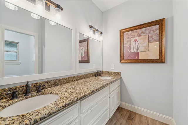 a utility room with lots of clutter and wooden cabinets