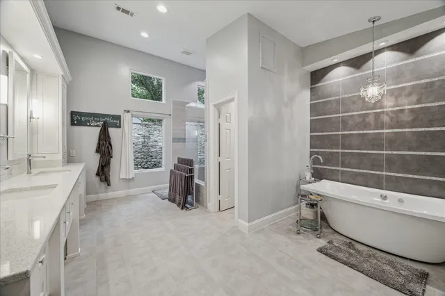 a kitchen with a sink a stove a refrigerator and white cabinets