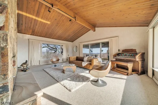 a view of a livingroom with furniture and floor to ceiling window