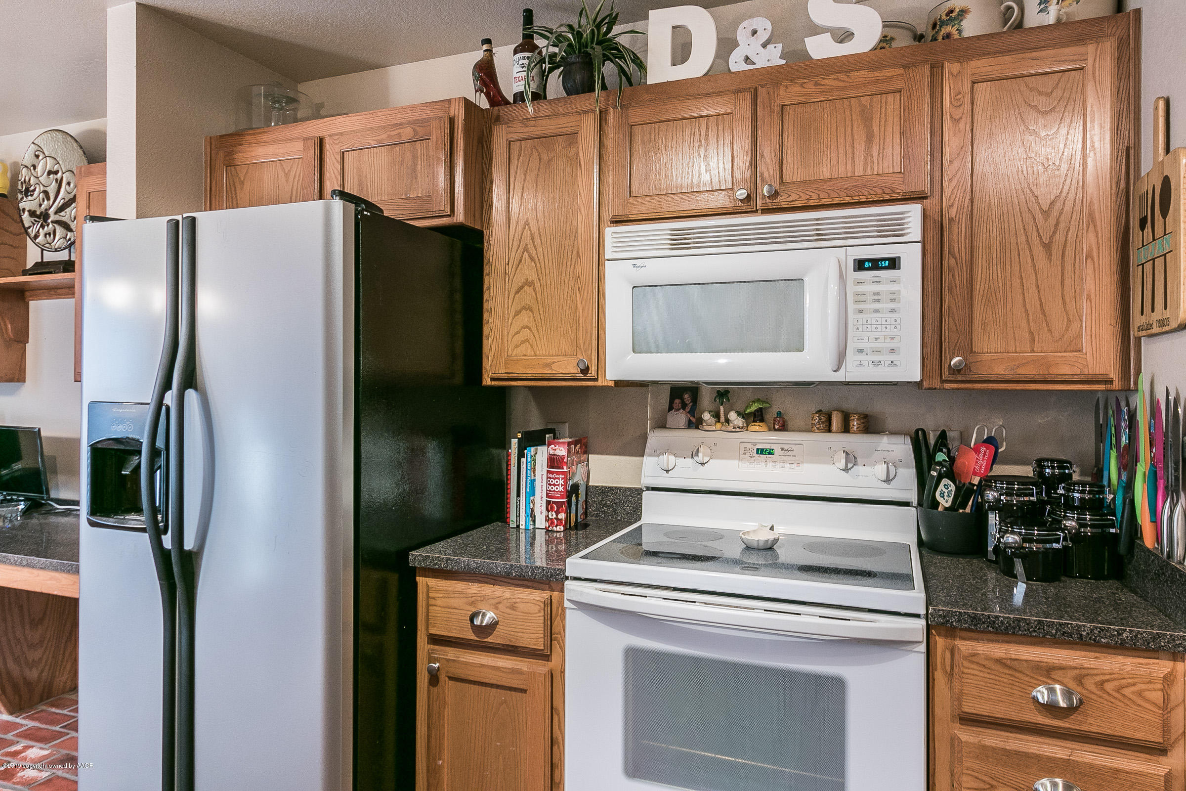 1168 Rushmore Drive Amarillo, TX 79110 - Photo 11 of 25 a kitchen with stainless steel appliances granite countertop a refrigerator and a stove top oven