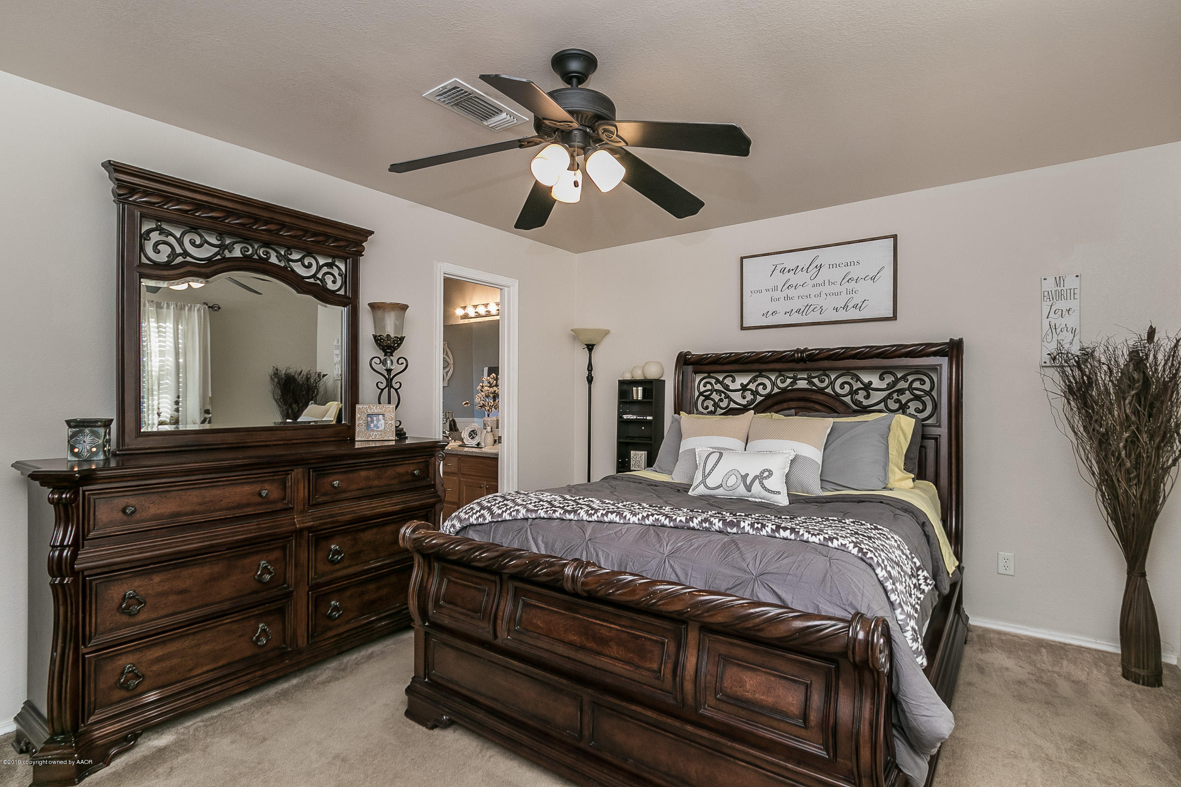 1168 Rushmore Drive Amarillo, TX 79110 - Photo 14 of 25 a bedroom with a bed and a chandelier