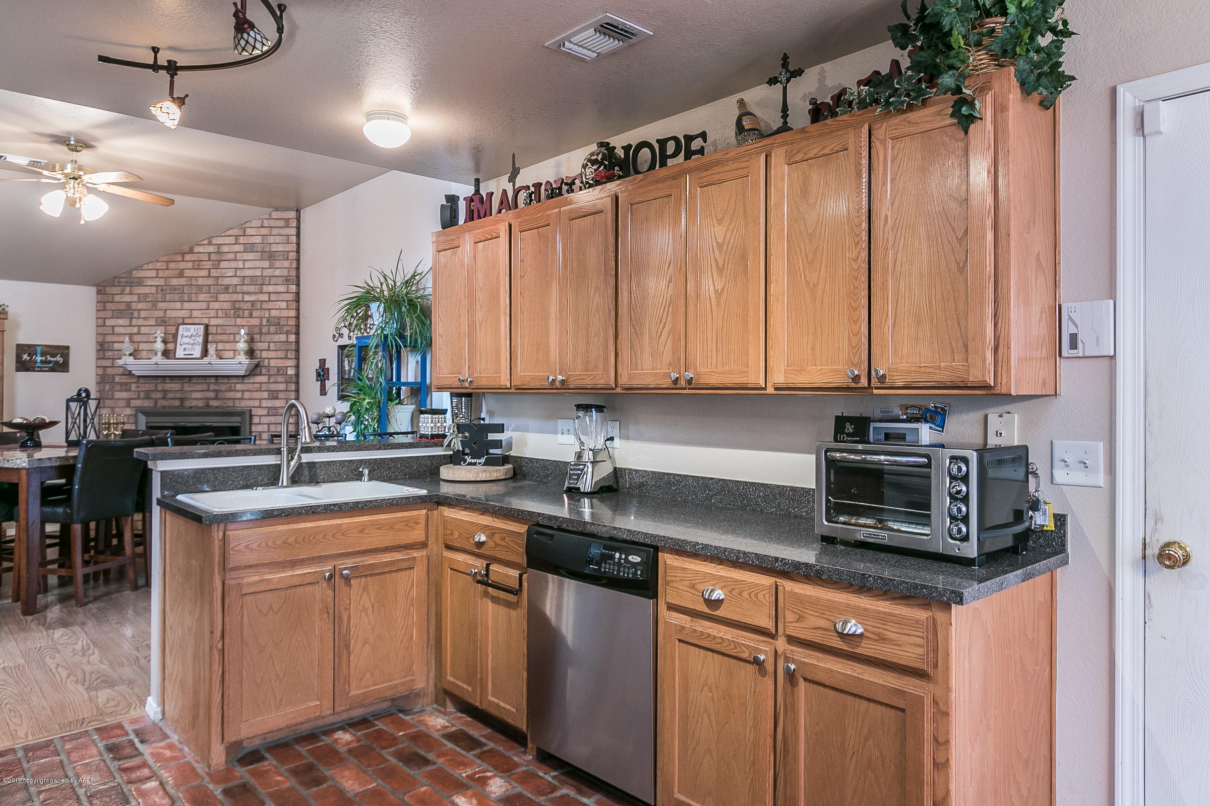 1168 Rushmore Drive Amarillo, TX 79110 - Photo 10 of 25 a kitchen with stainless steel appliances granite countertop a sink a stove and cabinets