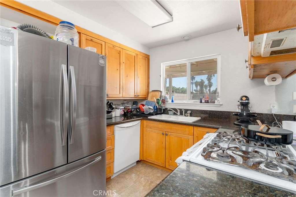 81901 Victoria Street Indio, CA 92201 - Photo 11 of 29 a kitchen with stainless steel appliances granite countertop a refrigerator and a sink